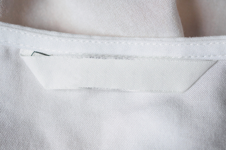 White blank laundry care clothes label on cotton shirtの写真素材