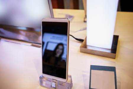 New mobile smartphone in telecommunication electronic store display showcaseの写真素材