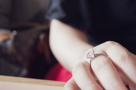 engagement diamond ring on woman finger closeupの写真素材