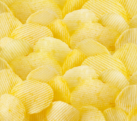 crispy potato chips snack texture backgroundの写真素材