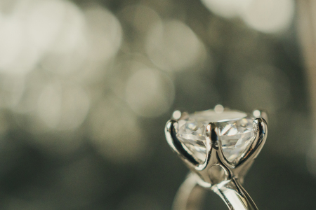 luxury engagement Diamond ring with abstract bokeh light backgroundの写真素材