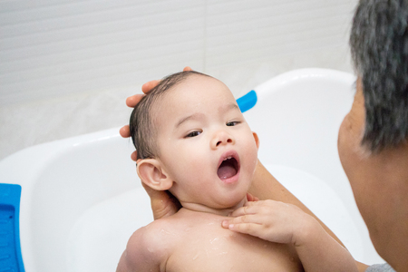 Happy asian baby girl having bath time