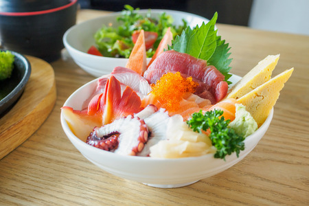 Sashimi Rice Bowl Chirashi Don Japanese food on wood table in restaurantの写真素材