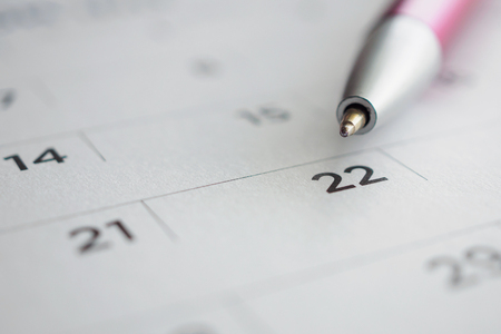 Calendar page with pen point at 22nd dateの写真素材