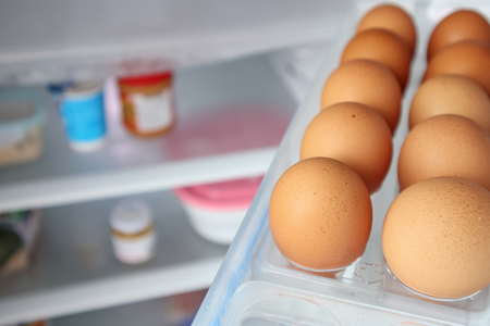 eggs arrange on refrigerator shelfの写真素材