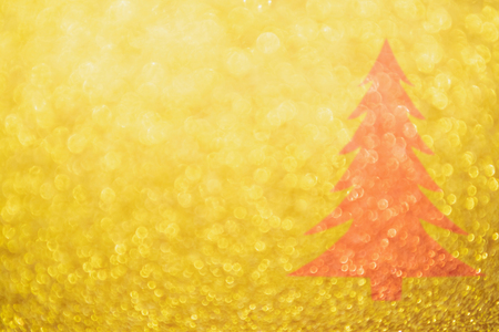 Abstract Gold glitter festive with red Christmas tree texture background blur with bokeh lightの写真素材