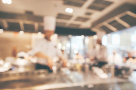 Chef cooking in restaurant kitchen blurred defocused backgroundの写真素材