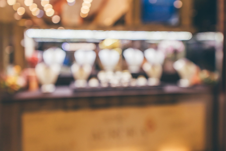 Gold jewelry diamond store window display abstract blur with bokeh light backgroundの写真素材