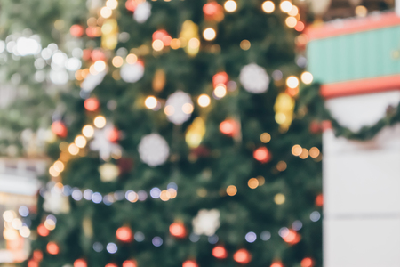 Abstract christmas holiday with festive gold bokeh light on tree blurred backgroundの写真素材