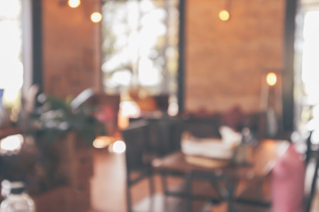 Restaurant cafe or coffee shop interior with customer blur abstract vintage style bokeh light for montage product display backgroundの写真素材