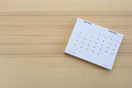 calendar page on wood table backgroundの写真素材