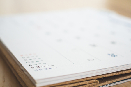 calendar page on wood table backgroundの写真素材