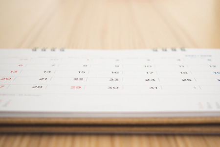 calendar page on wood table backgroundの写真素材