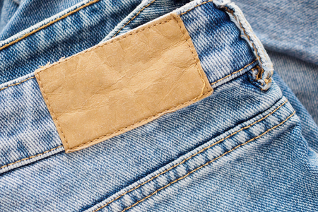 Blue denim jeans leather label texture backgroundの写真素材