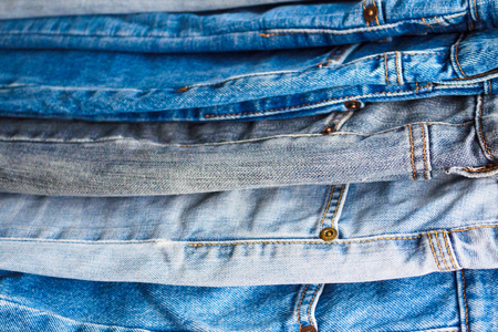 denim blue jeans stack texture background closeupの写真素材