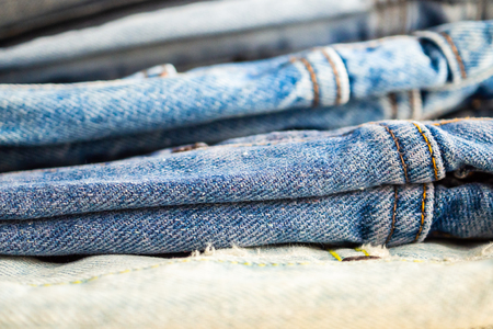 denim blue jeans stack texture background closeupの写真素材