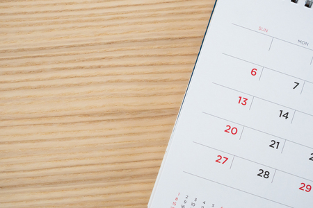 calendar page on wood table backgroundの写真素材