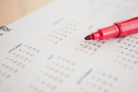 calendar page with red pen close upの写真素材