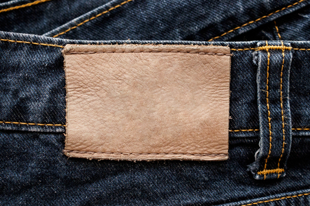 Blue denim jeans leather label texture backgroundの写真素材