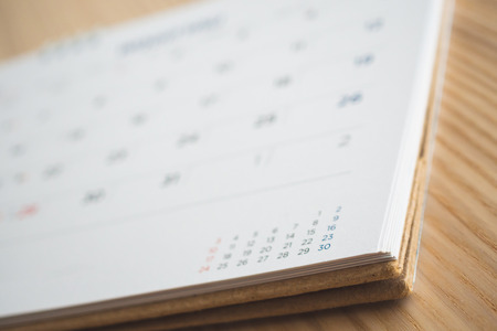 calendar page on wood table backgroundの写真素材