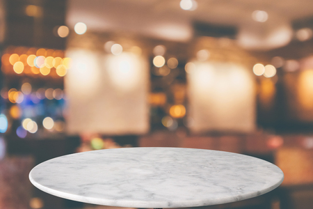 round marble table top with cafe restaurant bokeh lights abstract background for montage product displayの写真素材