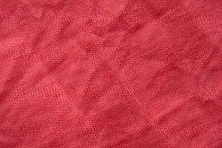 Red linen shirt fabric texture backgroundの写真素材