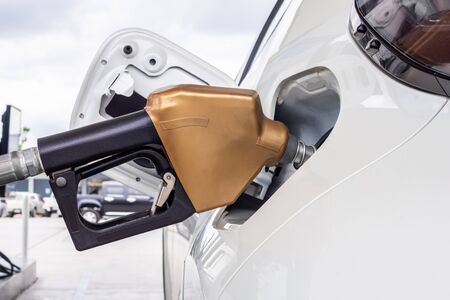White car refueling at petrol gas station