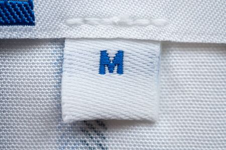 White clothes label close up on new shirt