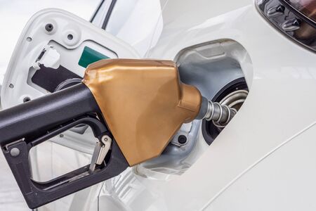 White car refueling at petrol gas stationの写真素材