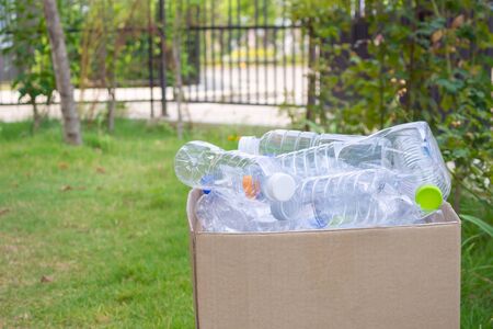 plastic bottles in brown recycle garbage boxの写真素材