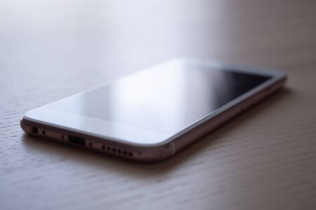 Mobile smartphone on wood table background
