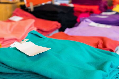 Blank white clothes tag on new shirt in store