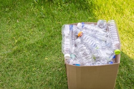plastic bottles in brown recycle garbage boxの写真素材