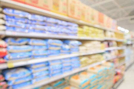 supermarket with rice bag on shelves blurred defocused background with bokeh lightの写真素材