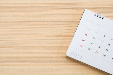 calendar page on wood table backgroundの写真素材