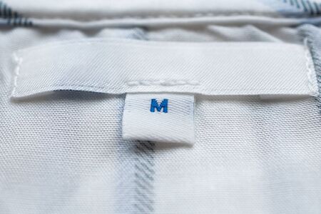 White clothes label close up on new shirtの写真素材