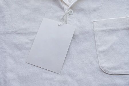 Blank white clothes tag label on new shirtの写真素材