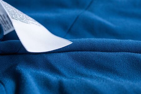 laundry care clothing label on blue dress