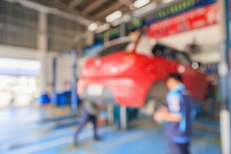 Red car lift at maintenance station in automotive service center blur abstract backgroundの写真素材
