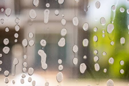 soap foam on window glass washing concept
