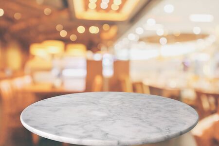 round marble table top with cafe restaurant bokeh lights abstract background for montage product displayの写真素材