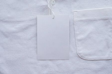 Blank white clothes tag label on new shirt