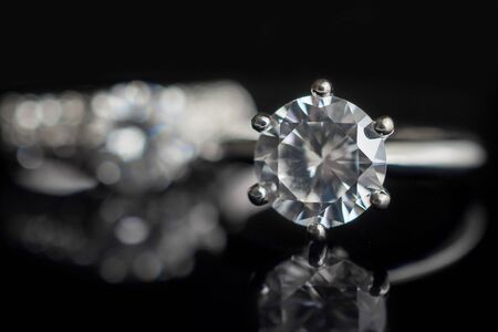 Jewelry wedding diamond rings on black background with reflection