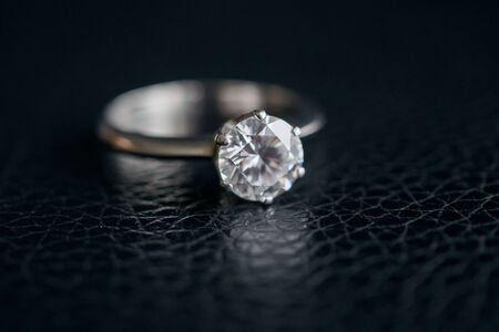 Close up diamond ring jewelry on black leather backgroundの写真素材