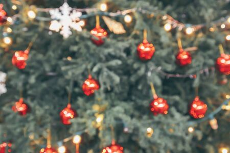 Abstract christmas holiday with festive gold bokeh light on tree blurred backgroundの写真素材
