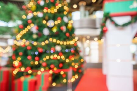 Abstract christmas holiday with festive gold bokeh light on tree blurred backgroundの写真素材