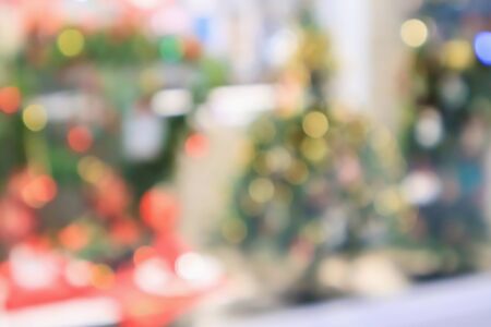 Abstract christmas holiday with festive gold bokeh light on tree blurred backgroundの写真素材