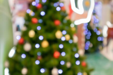 Abstract christmas holiday with festive gold bokeh light on tree blurred backgroundの写真素材