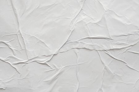 Blank white crumpled and creased paper poster texture backgroundの写真素材