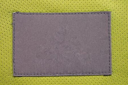 laundry care clothing label patch on polyester fabric jersey sport texture